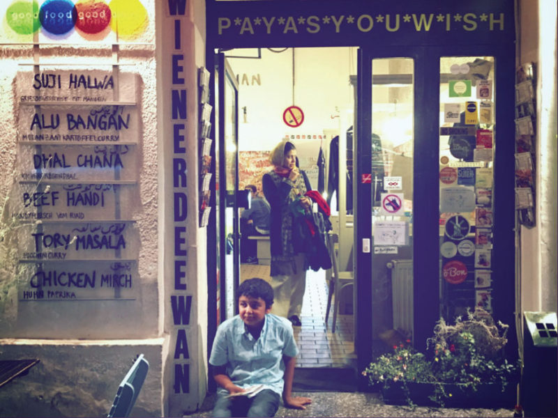 Asad sits on the step in front Der Wiener Deewan, satisfied by the hearty Pakistani meal